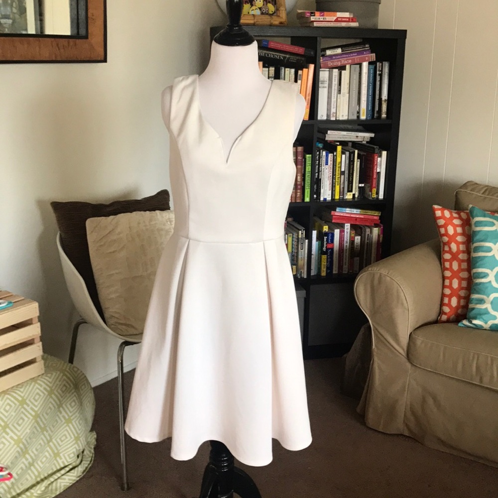 White sleeveless V neck dress.